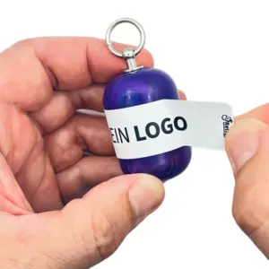 Erste-Hilfe Set als Streuartikel – ideal als Giveaway & personalisiertes Kundengeschenk – mit Logo bedrucken lassen mit lila Kapsel beim öffnen