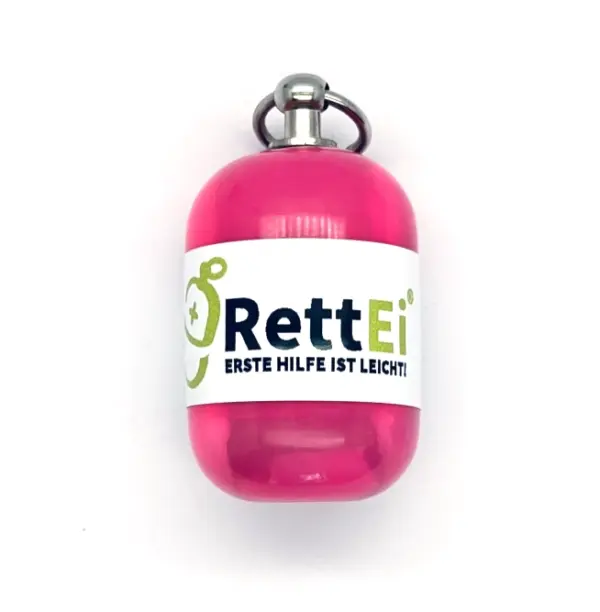Notfall-Set-fuer-unterwegs-als-RettEi-Original-via-Erste-Hilfe-Schluesselanhaenger-mit-Beatmungstuch-zur-Mund-zu-Mund-Beatmung-mit-rosa-Kapsel-in-Seitenansich