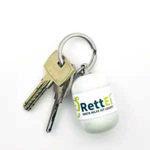 Notfall-Set-fuer-unterwegs-als-RettEi-Original-via-Erste-Hilfe-Schluesselanhaenger-mit-Beatmungstuch-zur-Mund-zu-Mund-Beatmung-mit-weiss-Kapsel-am-Schluesselbund