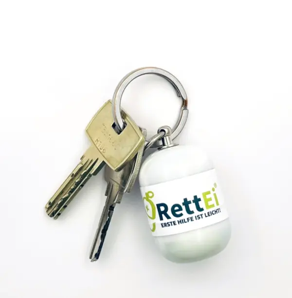 Notfall-Set-fuer-unterwegs-als-RettEi-Original-via-Erste-Hilfe-Schluesselanhaenger-mit-Beatmungstuch-zur-Mund-zu-Mund-Beatmung-mit-weiss-Kapsel-am-Schluesselbund