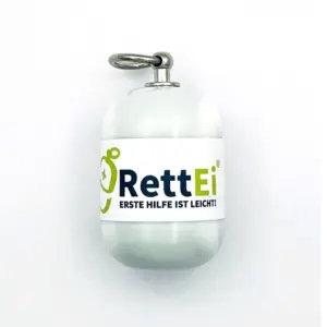 Notfall-Set-fuer-unterwegs-als-RettEi-Original-via-Erste-Hilfe-Schluesselanhaenger-mit-Beatmungstuch-zur-Mund-zu-Mund-Beatmung-mit-weiss-Kapsel-in-Seitenansicht.
